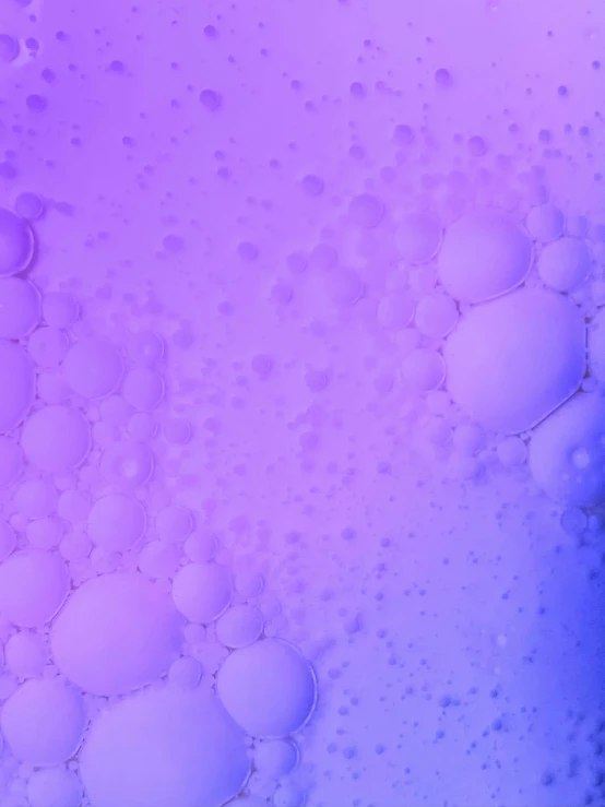 bubbles and soap are on a purple surface