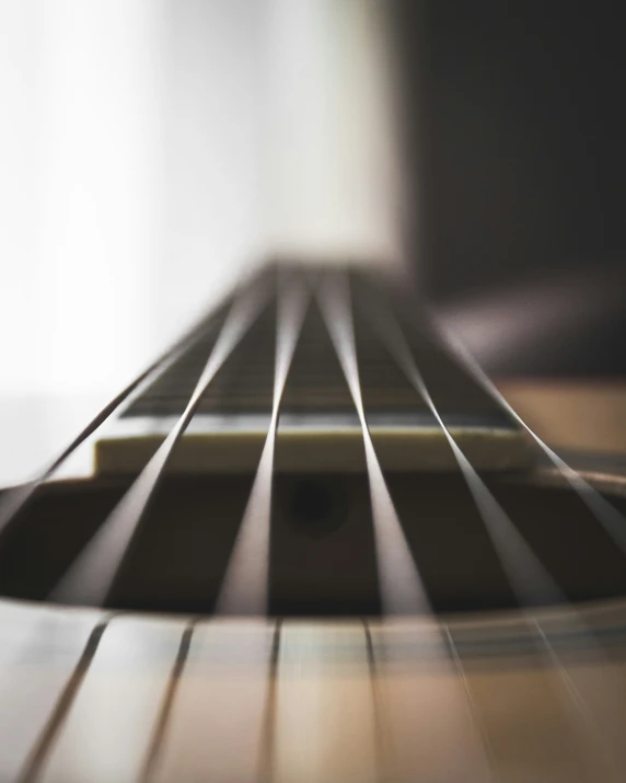 a guitar neck sitting on a wood floor