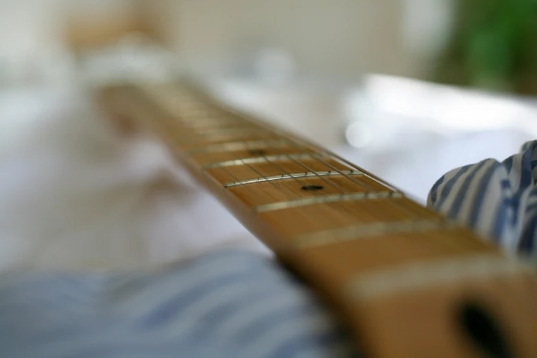 a closeup of a guitar neck on a person