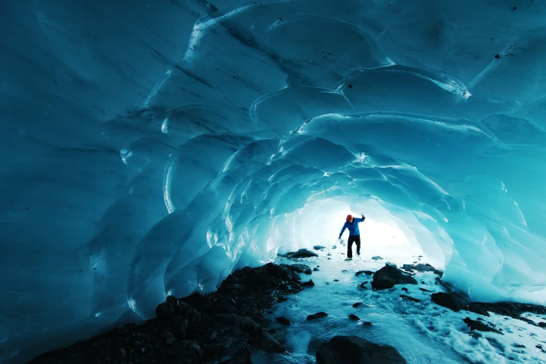 a man standing in an icy ice cave