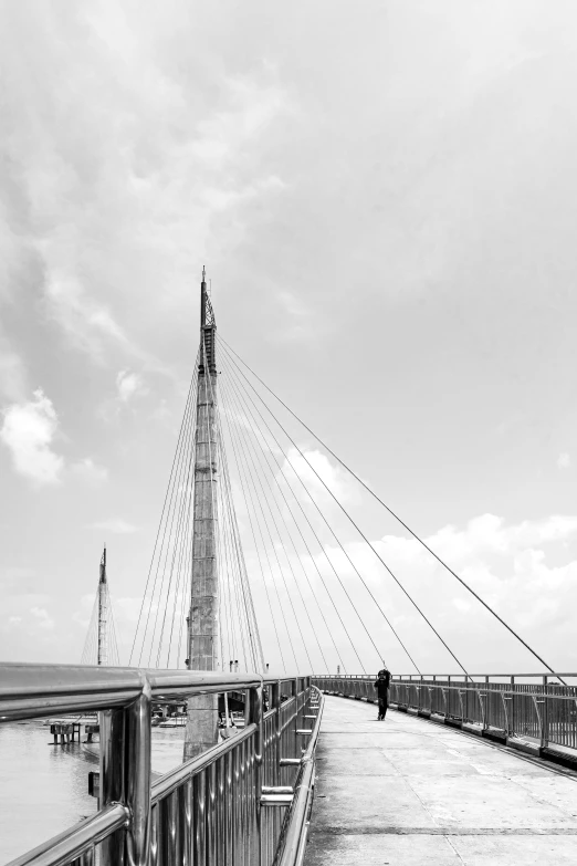 people walking along a pier towards the water