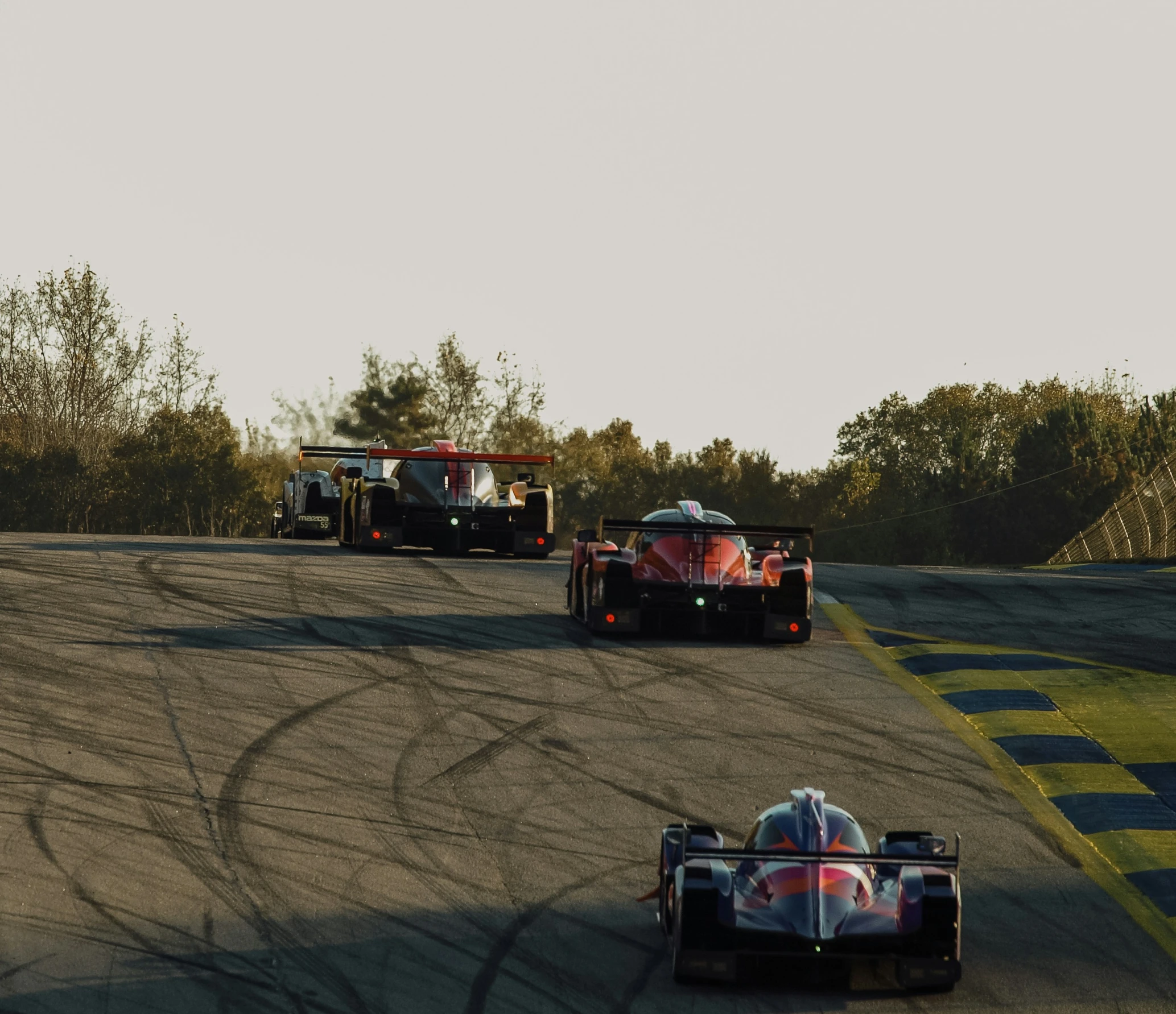 three cars go around the bend at a turn