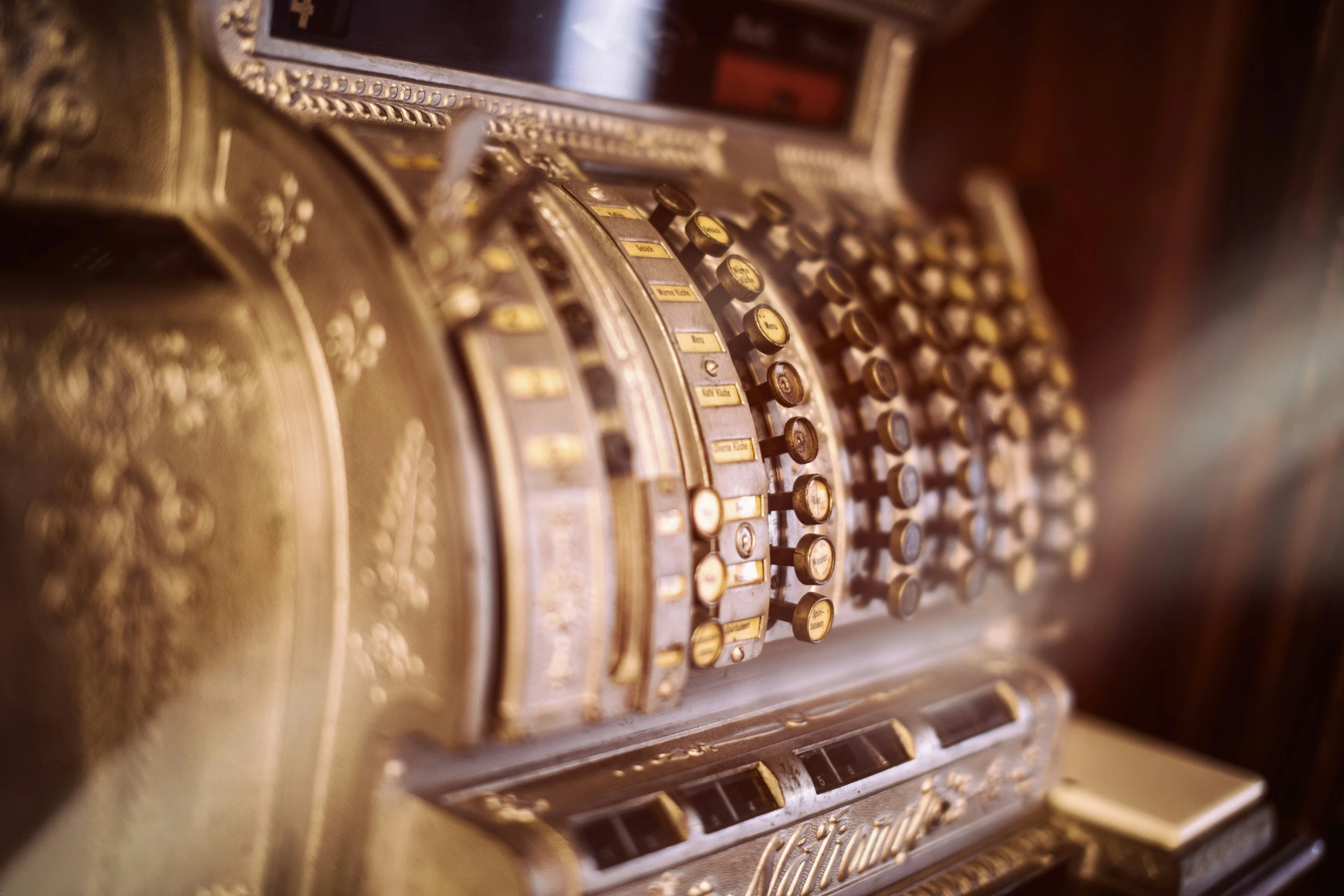 old fashioned style cash register with coins on it
