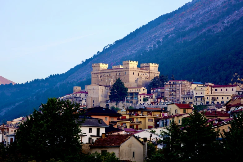 old buildings sit in front of a mountain