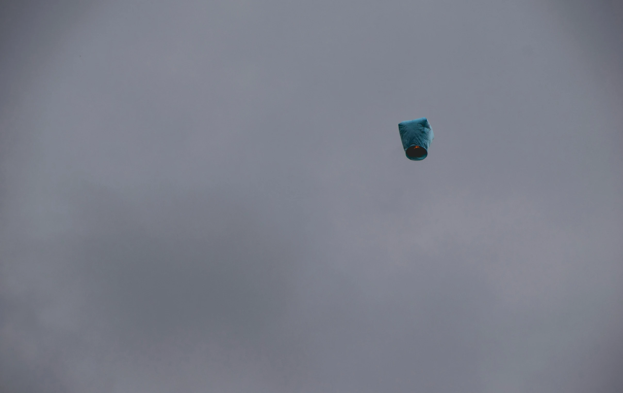 the view from the ground shows a kite flying high