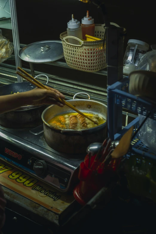 two pots are next to some food in the oven