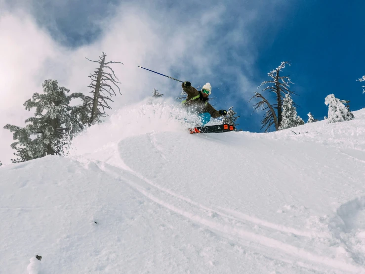 a snowboarder is performing a high jump on the slopes