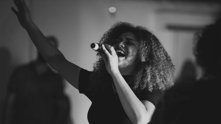 woman singing into a microphone at a party