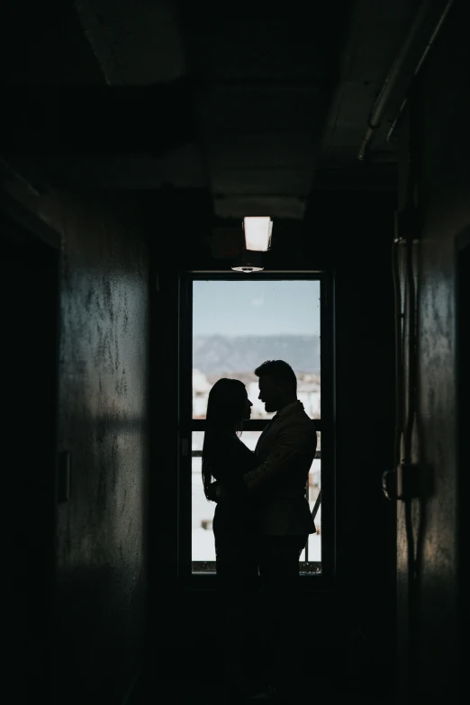 the silhouettes of two people facing each other with their backs turned