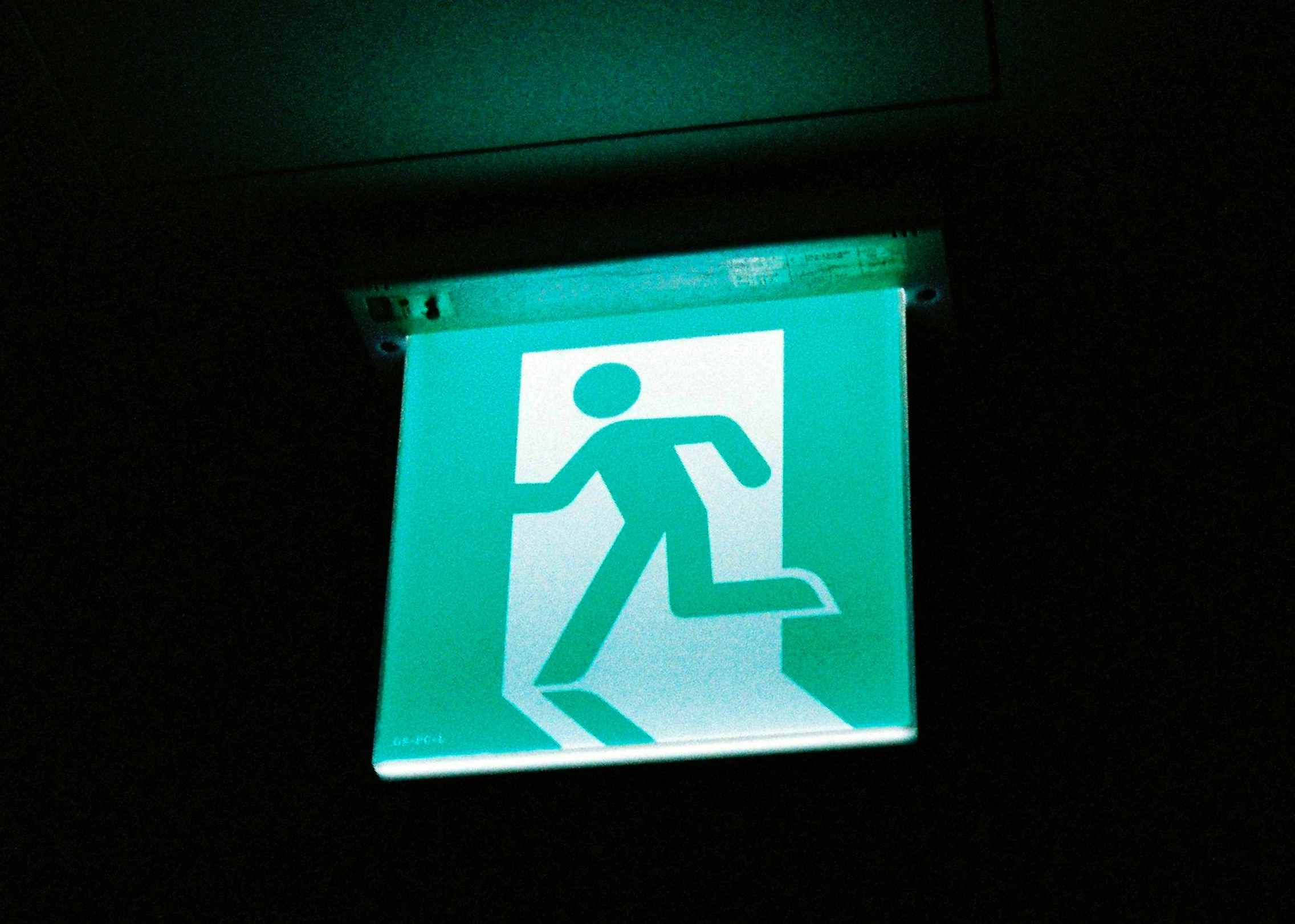 there is a sign with a person holding a backpack