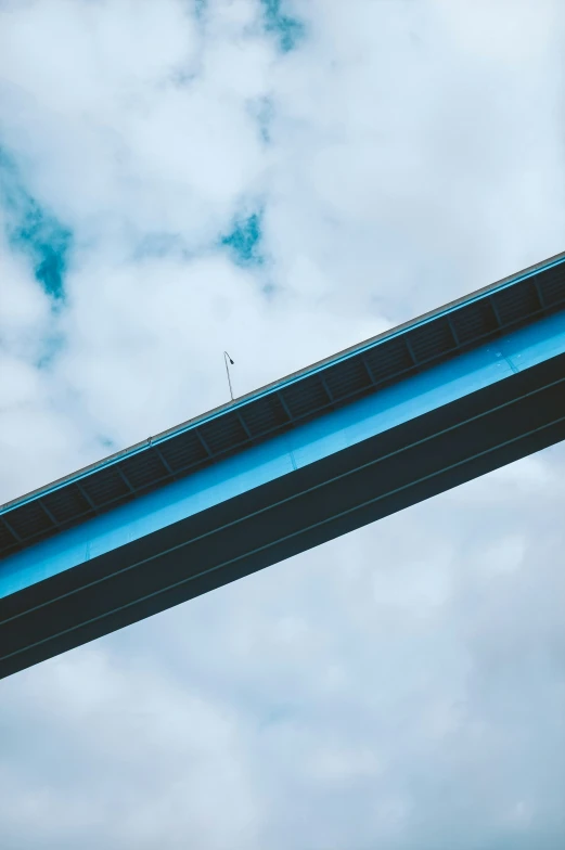 two birds perched on the railing above a freeway