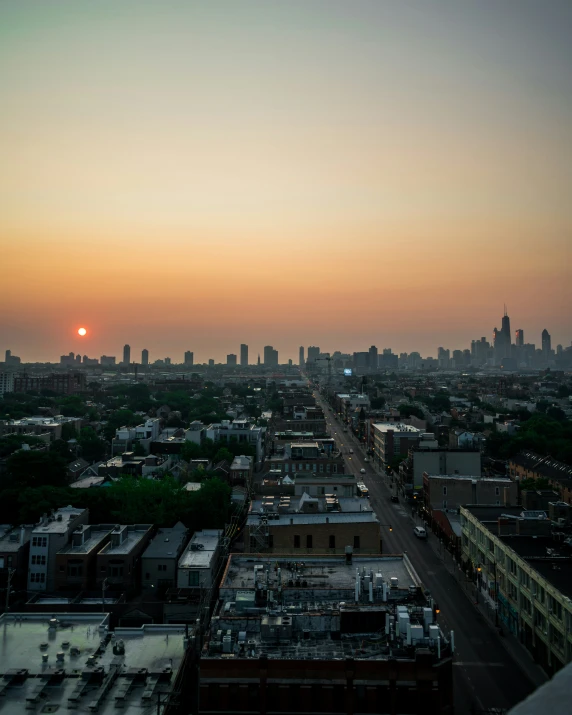 a view of a city at sunset from above