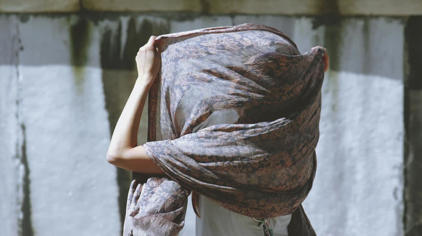 a woman in scarf wrapped around her head