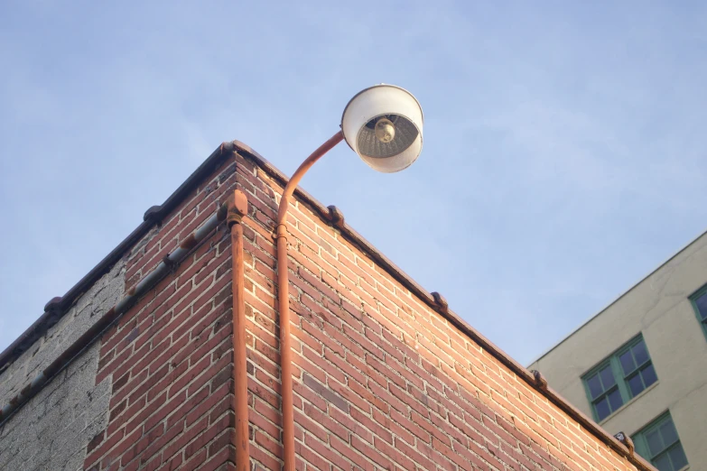 a fan on top of a building against a blue sky