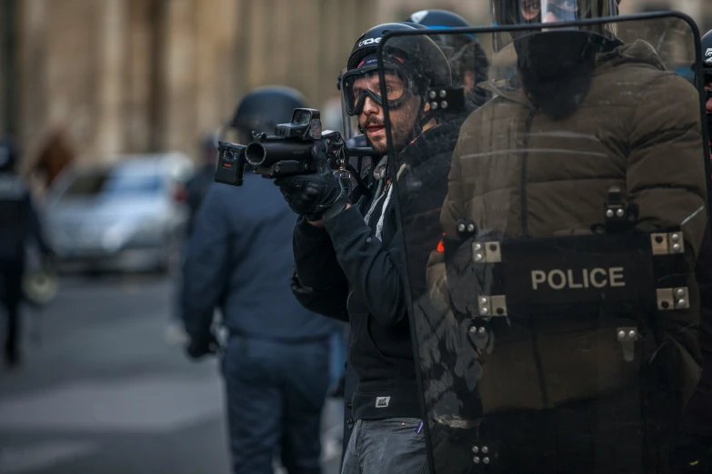 a man holding a camera while standing next to another person