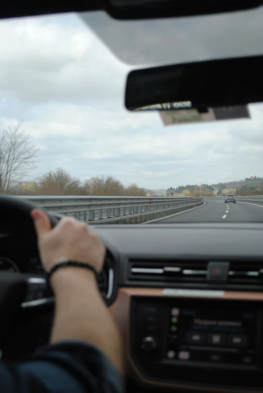 the interior of a vehicle looking down the highway