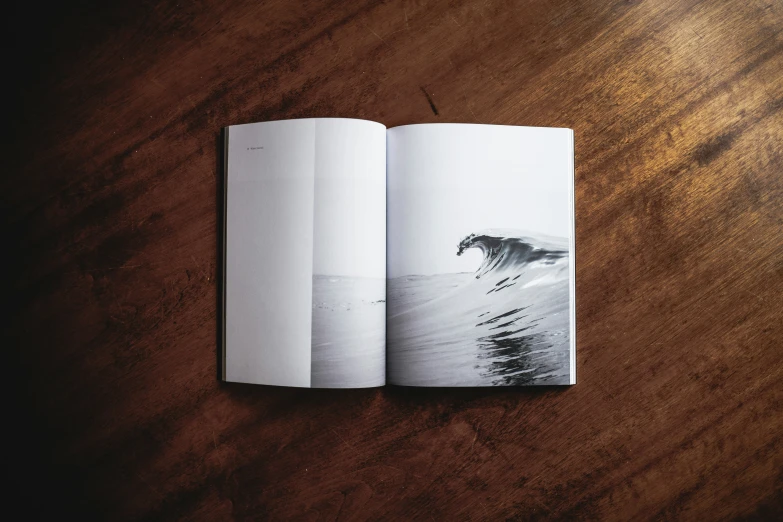 the opened book shows an image of a surfer's wave