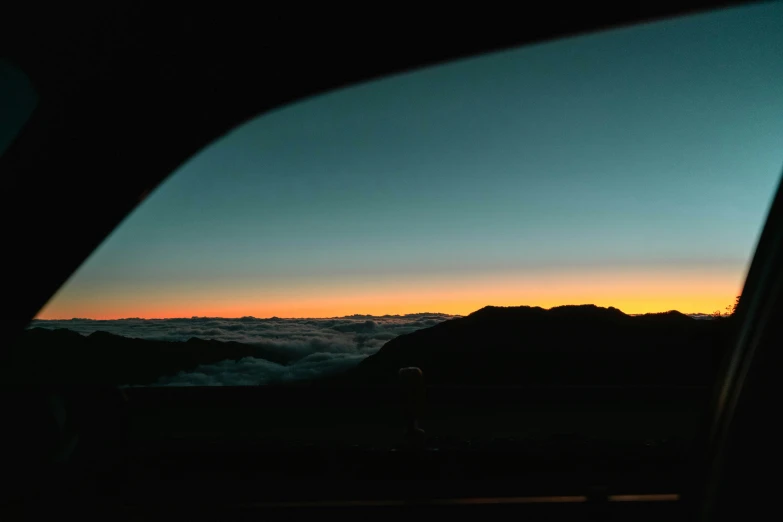 the sky, mountain and valley seen from inside a car