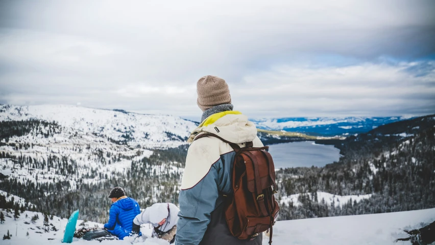 two men are looking at the mountains from above