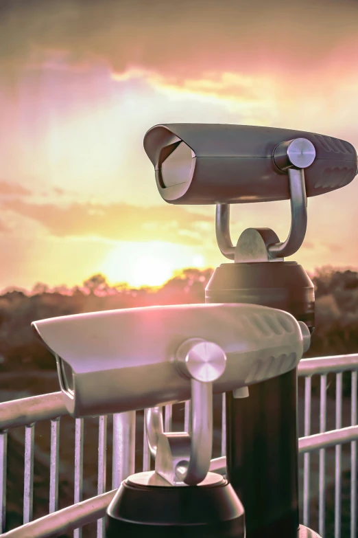 an outdoor camera is perched on top of a post