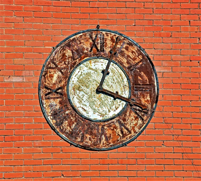 there is a round clock on the brick wall