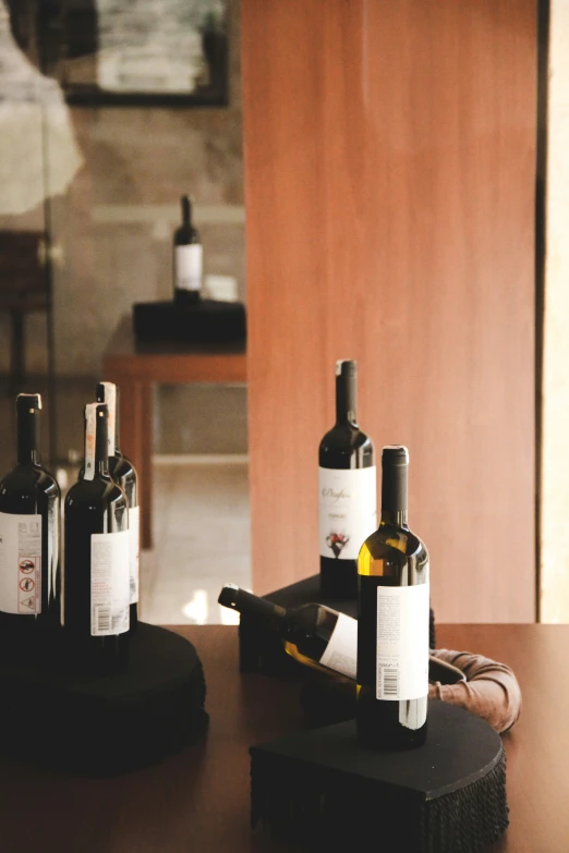 a wooden table topped with bottles of wine