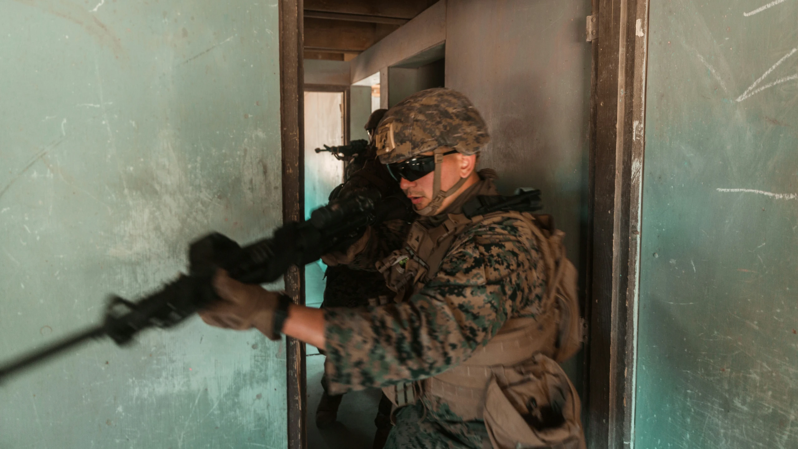 a man holding a machine gun with camouflage