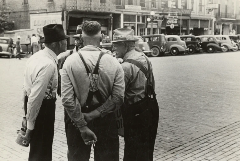 some men are talking to each other in the street