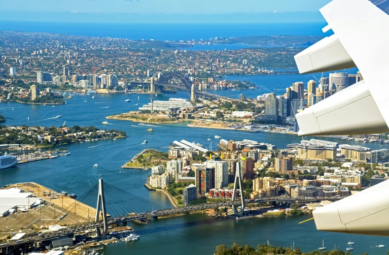 an aerial view from the airplane of some buildings and water