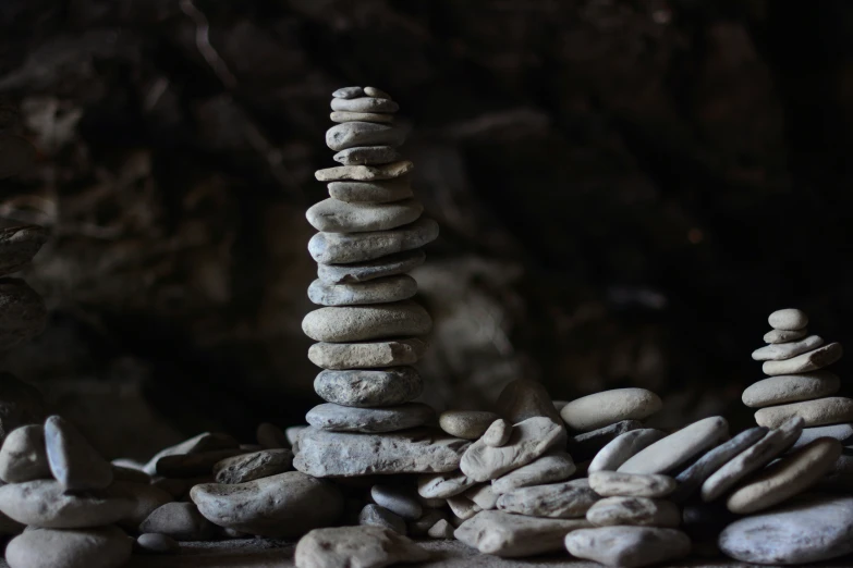 a stack of white rocks is in front of a rock - like structure