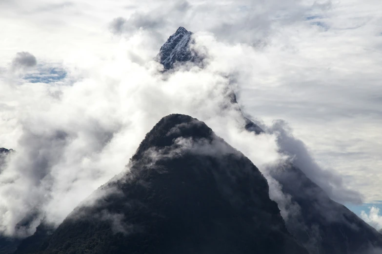 mountains are obscured by clouds near the top of them