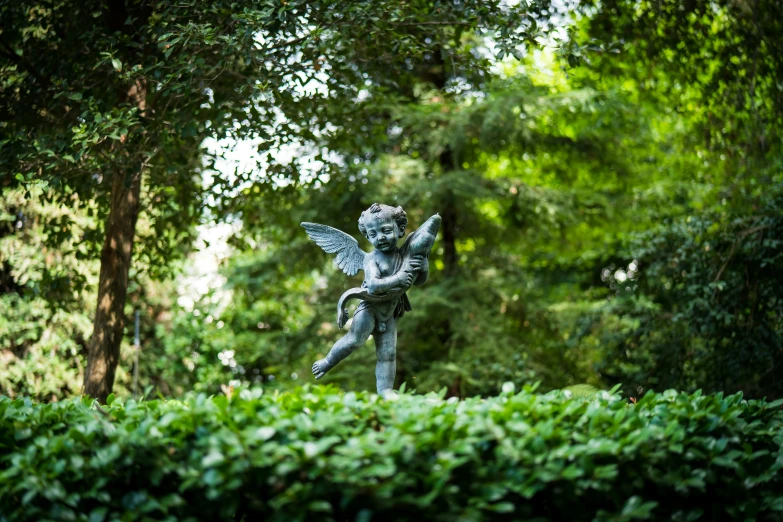 the statue is sitting alone in the park