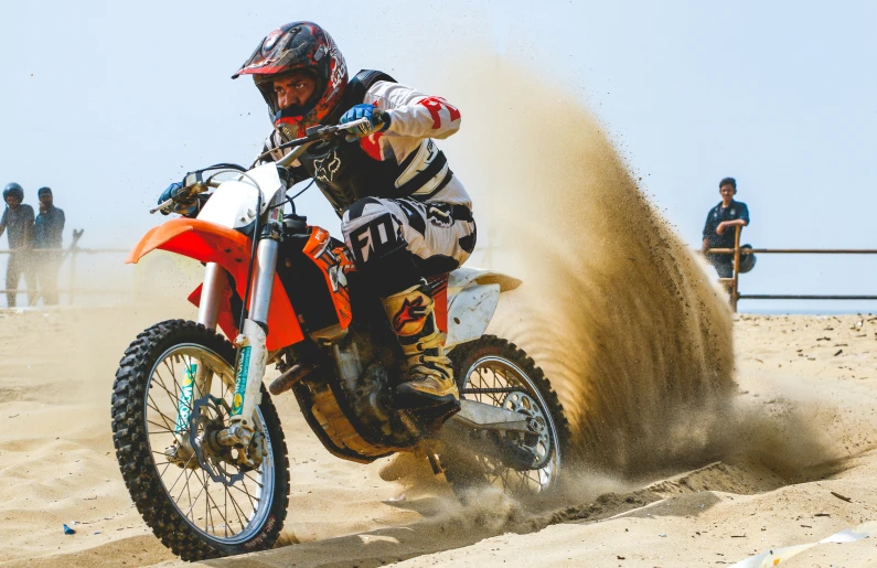 a person on a dirt bike in the sand