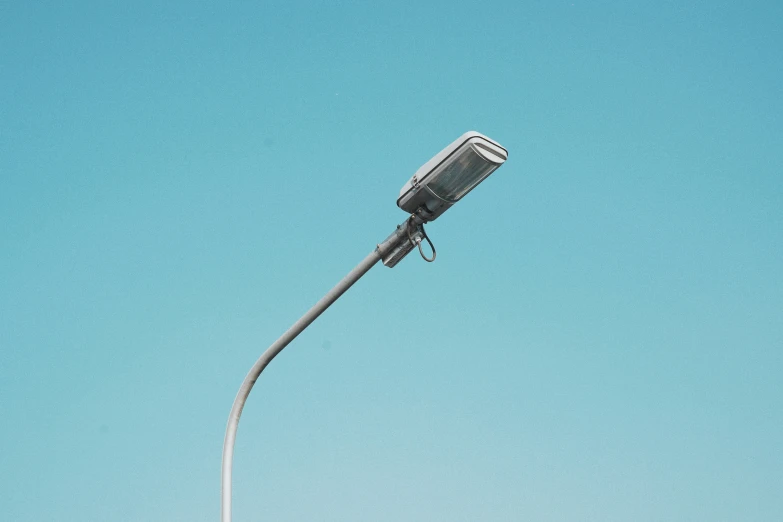 a lamp on a post against a blue sky