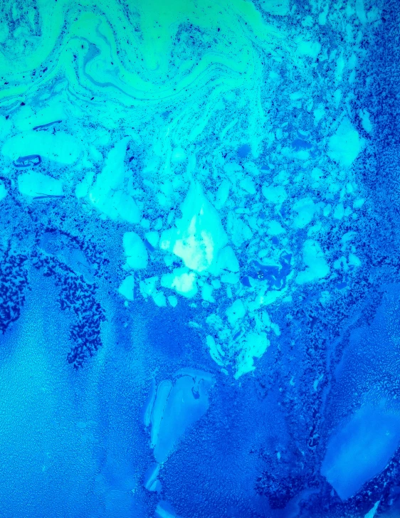 blue and green sea foam in the ocean water