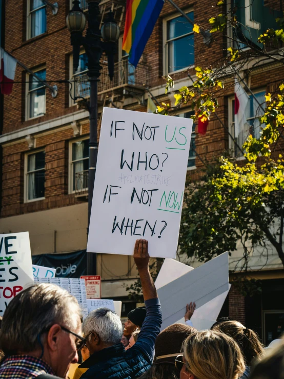 people holding up signs in the middle of a street
