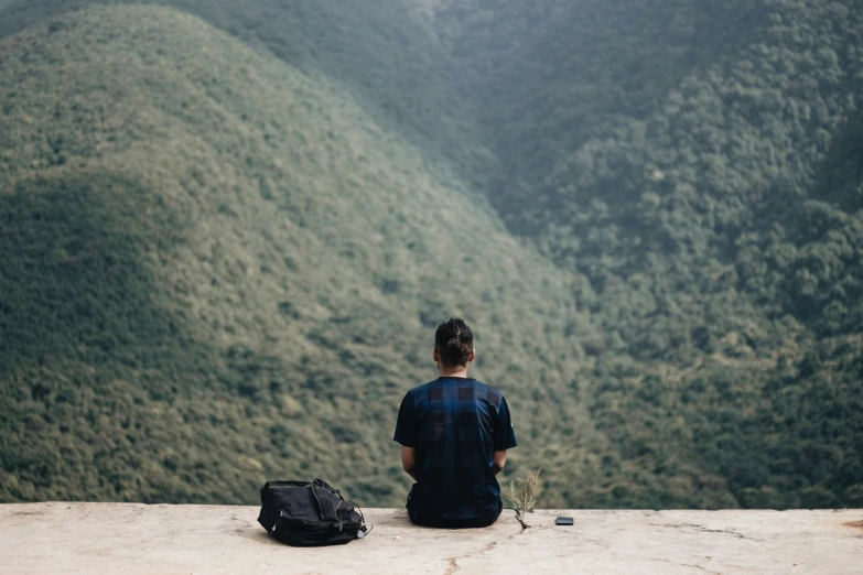 a person with a backpack on top of a hill