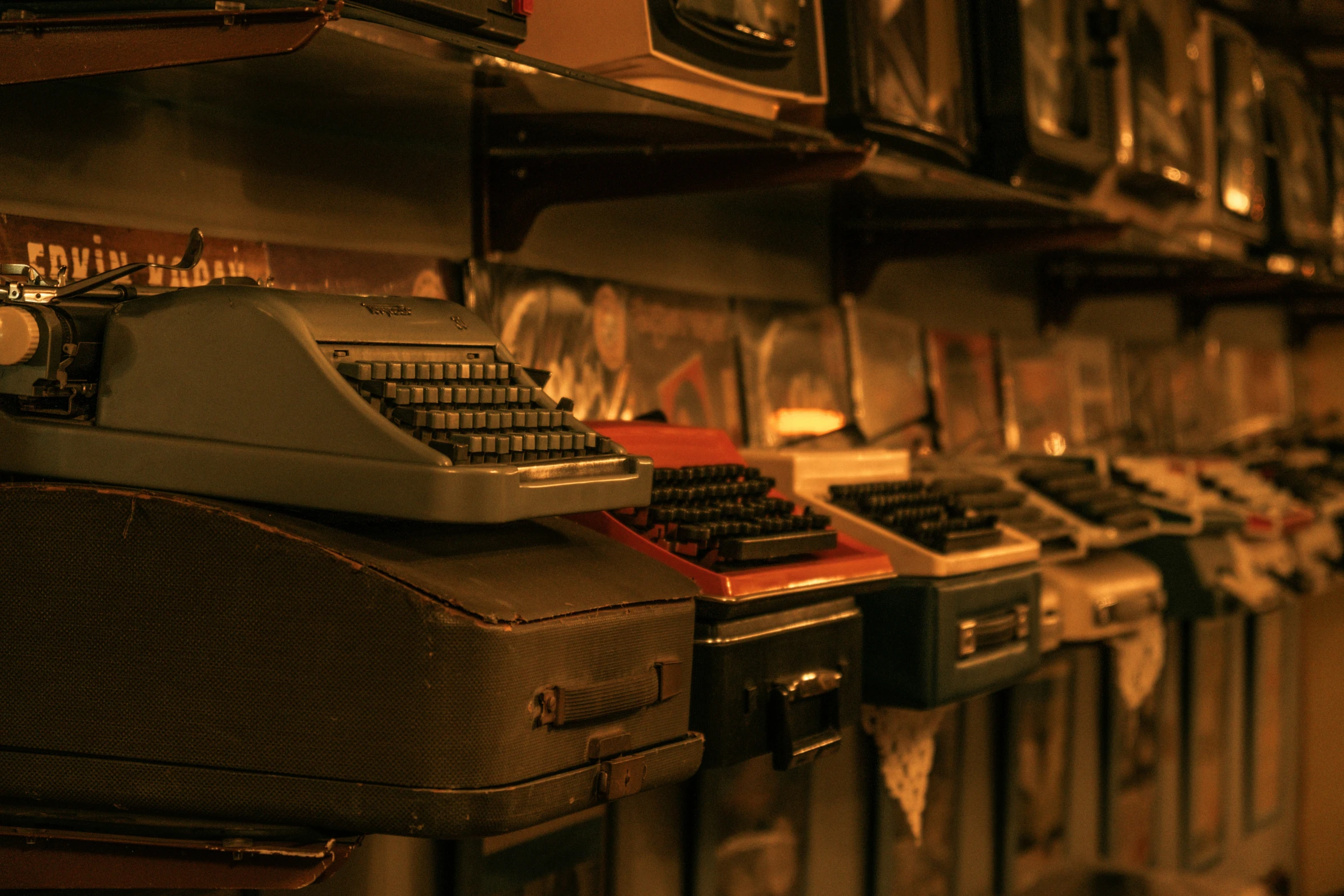 an old typewriter sits on the wall next to other equipment