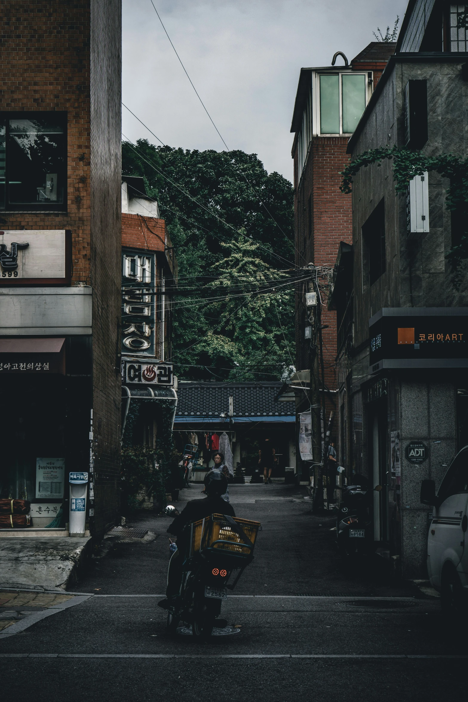 a street with many buildings, cars and people