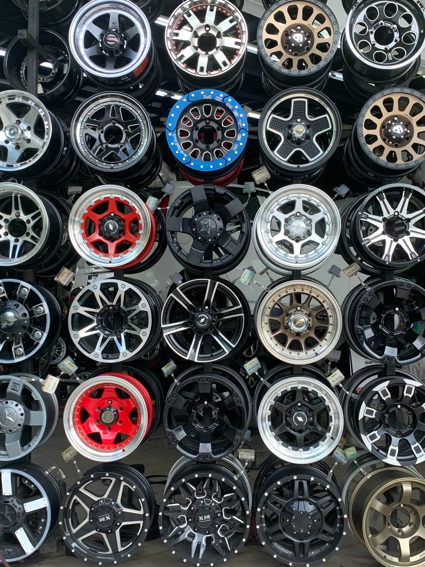 assortment of rims in garage shop