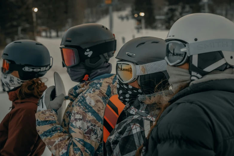 group of snowboarders in full gear standing in the snow