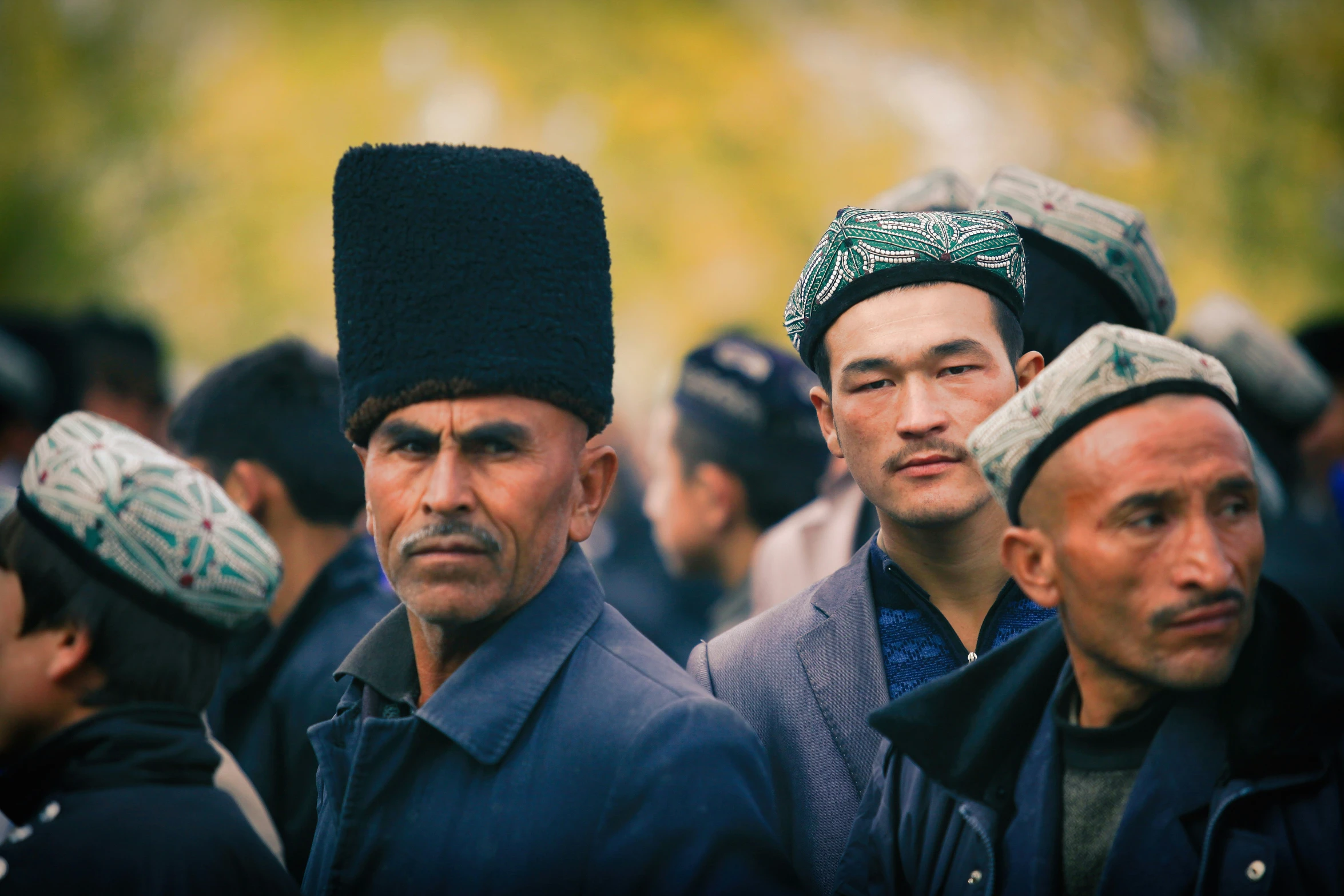 many people are wearing green hats while standing