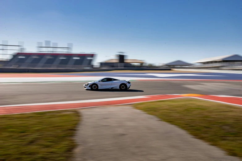 the car is driving around the corner on a race track