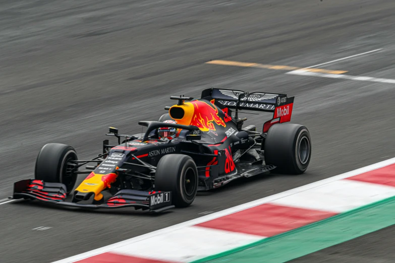 a car with red and yellow stripes going down the track