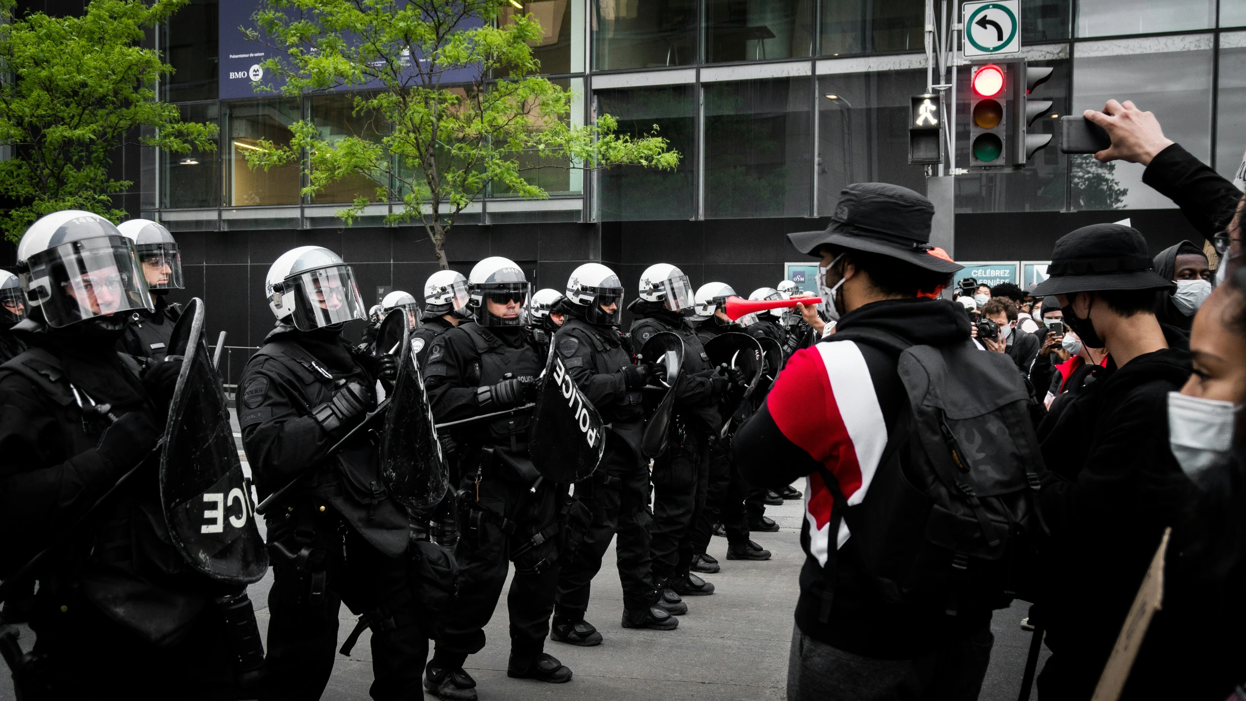 a group of protesters wearing black and white standing on the street