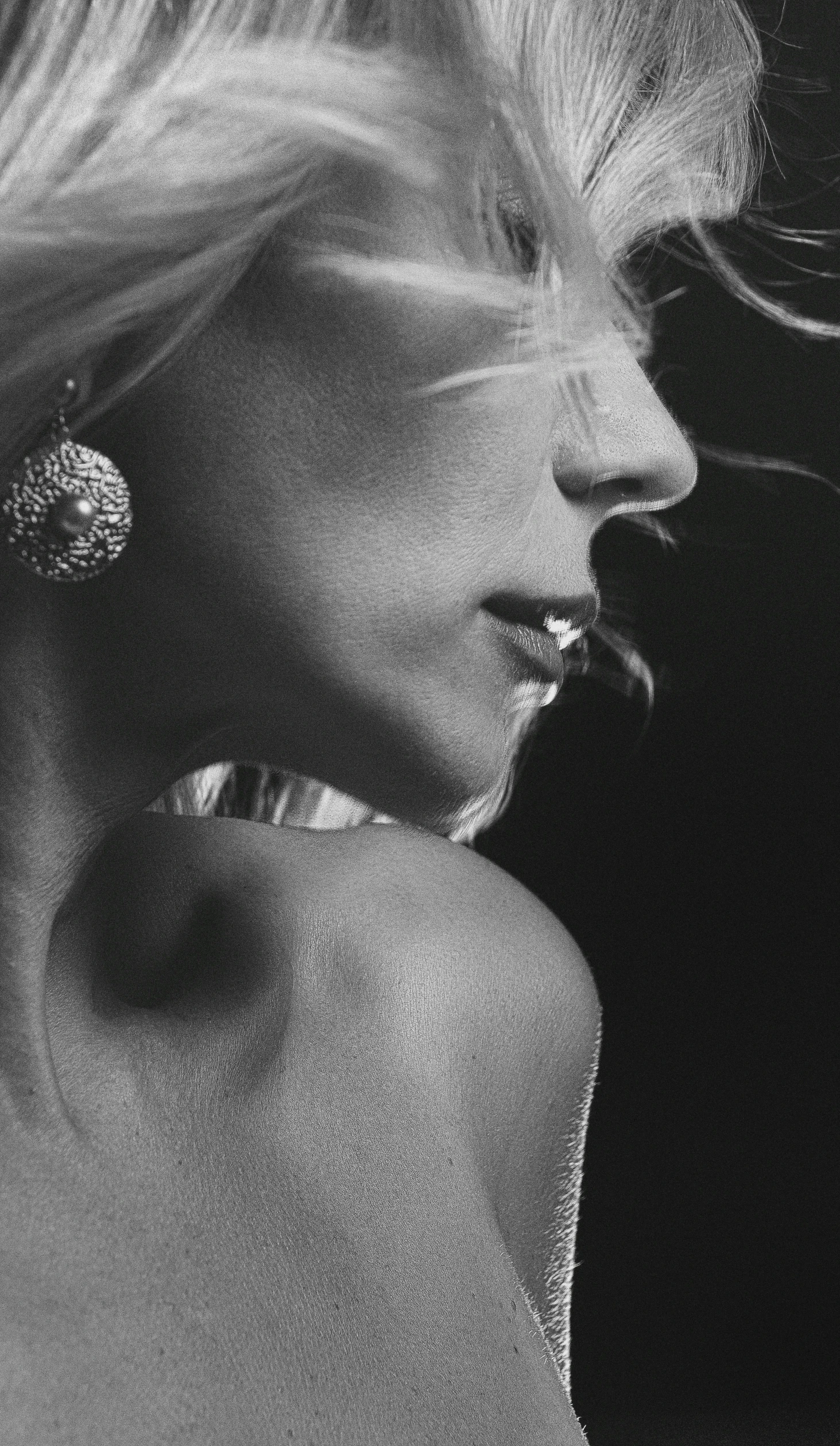 a woman in a black and white pograph with earrings