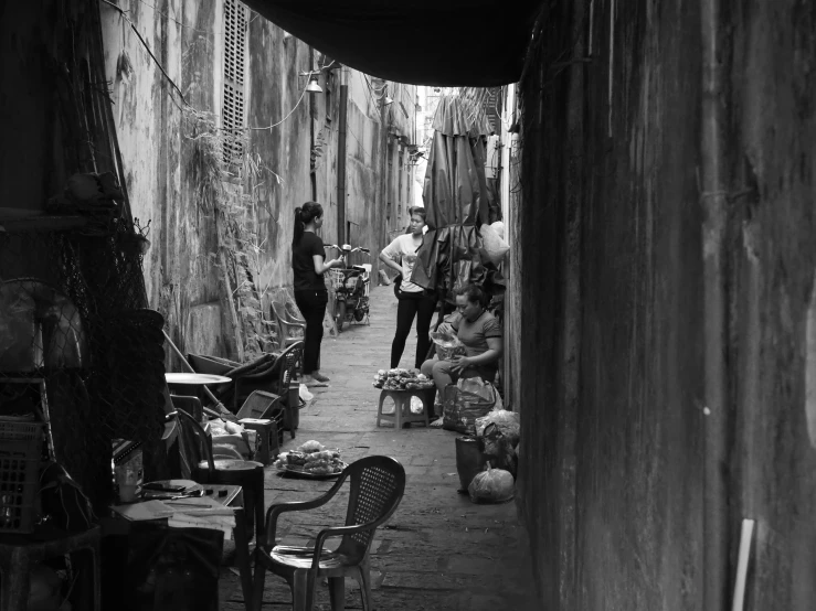 a black and white po of people in the alleyway