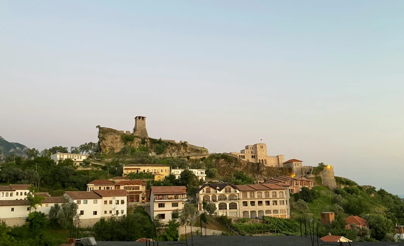 a bunch of buildings are on top of a hill