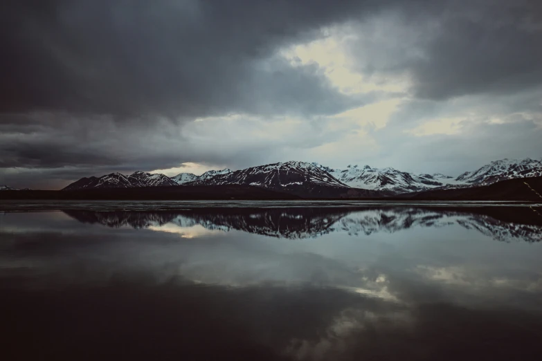 a large body of water with a mountain in the background