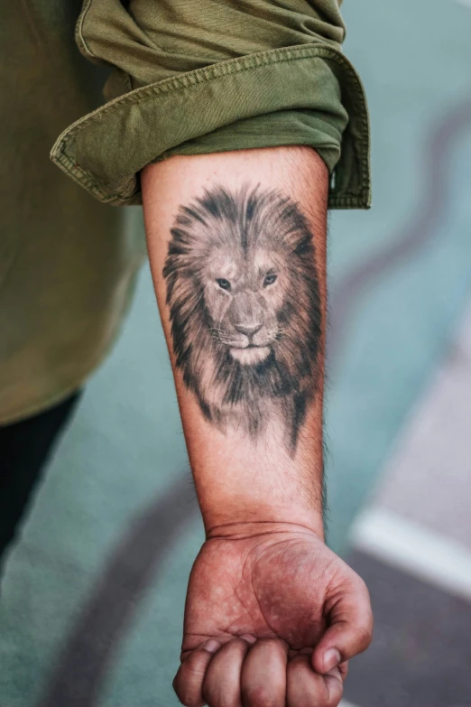 a hand with a lion tattoo on it